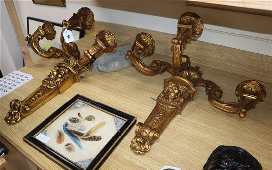 A pair of three branch gilt lion decorated sconces height 56cm